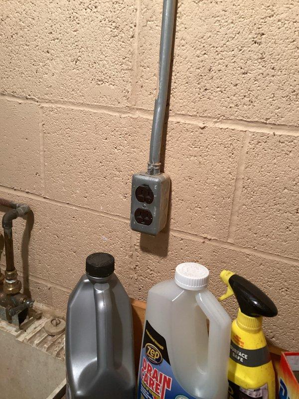 Performed complimentary electrical inspection of residential service panel and utility area receptacles. Inspected main disconnect switch (Square D R343 series), verified proper cable terminations at terminal blocks, and confirmed secure connections of incoming service conductors. Evaluated flexible metal conduit installation and mounting integrity on plywood substrate. Assessed downstream branch circuit protection and examined receptacle installation in utility area including proper grounding and box mounting on masonry wall. All components photographed for documentation purposes. System found to be in serviceable condition with no immediate safety concerns identified during visual inspection.