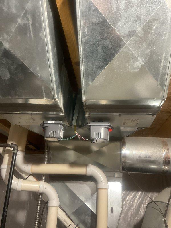 Completed comprehensive cooling system maintenance inspection in residential attic and basement mechanical spaces. Inspected all accessible ductwork, verified proper connections at main trunk junctions, checked condensate drain lines for proper pitch and secure mounting, and examined air handler components for operational integrity. Documented humidifier control unit status, verified electrical connections at junction boxes, and confirmed all mechanical equipment was functioning within normal parameters with no immediate service needs identified.