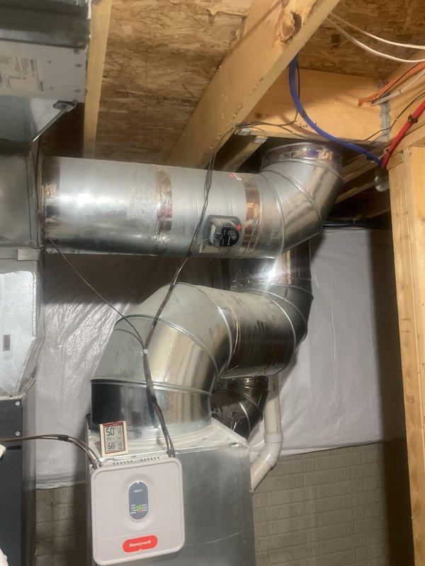 Completed comprehensive cooling system maintenance inspection in residential attic and basement mechanical spaces. Inspected all accessible ductwork, verified proper connections at main trunk junctions, checked condensate drain lines for proper pitch and secure mounting, and examined air handler components for operational integrity. Documented humidifier control unit status, verified electrical connections at junction boxes, and confirmed all mechanical equipment was functioning within normal parameters with no immediate service needs identified.
