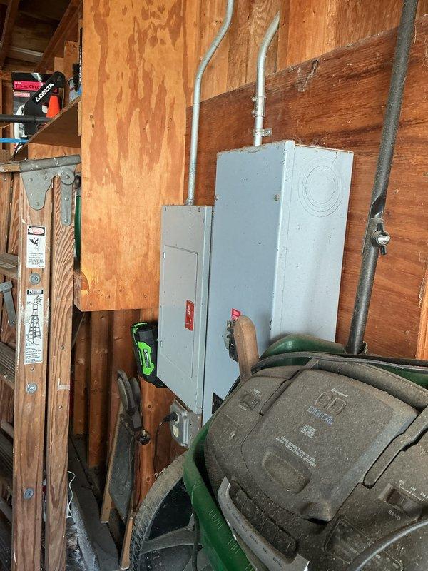Performed comprehensive electrical inspection of residential utility area and workshop space. Documented existing electrical panel installations, circuit breaker configurations, and conduit routing for compliance verification. Photographed electrical infrastructure including main service panels, copper wiring connections, and protective conduit systems to establish baseline condition assessment of the electrical distribution system.
