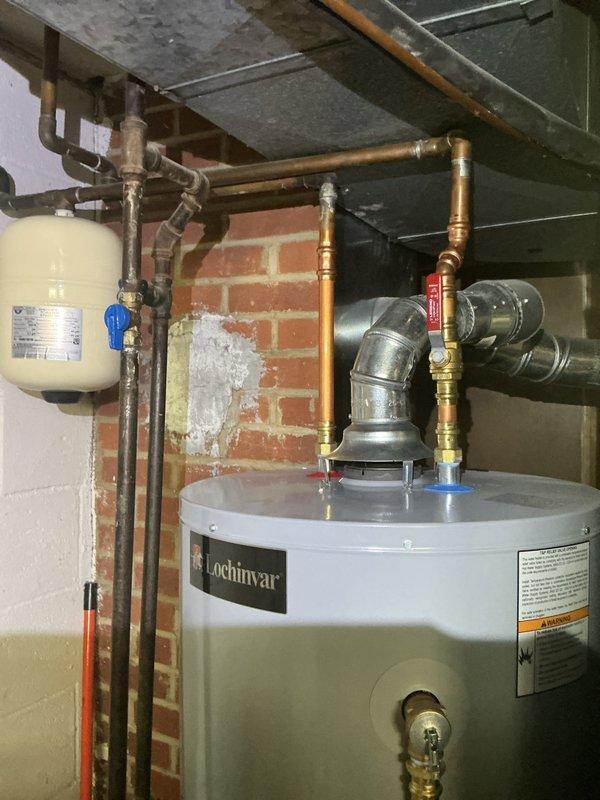 Conducted comprehensive electrical inspection of residential property. Documented electrical distribution panel showing proper circuit breaker arrangement and wire routing, and photographed mechanical room utility installations including water heater, plumbing connections, and associated electrical components to verify code compliance and system functionality.
