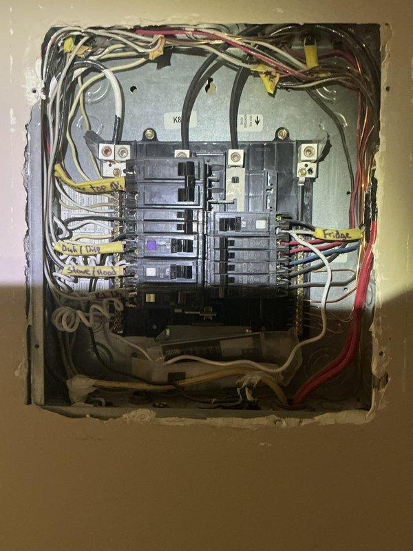 Conducted comprehensive electrical inspection of residential property. Documented electrical distribution panel showing proper circuit breaker arrangement and wire routing, and photographed mechanical room utility installations including water heater, plumbing connections, and associated electrical components to verify code compliance and system functionality.