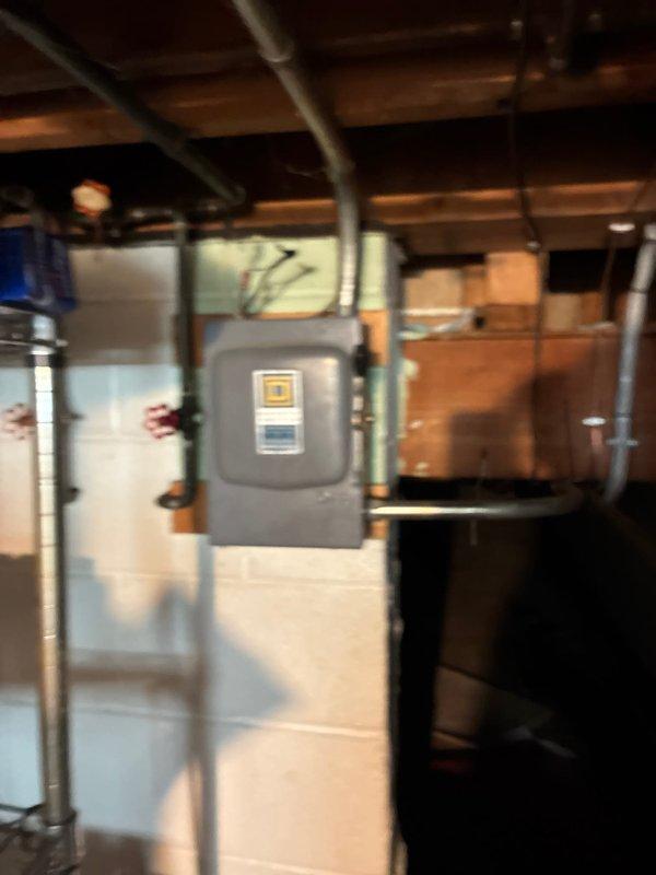 Conducted HVAC system replacement estimate at rental property with easy access to equipment located in basement utility area. Assessed existing gray metal furnace cabinet and associated electrical disconnect components, documented current system configuration and measurements for replacement specifications. Provided equipment replacement options to property owner for existing HVAC system serving the residence.
