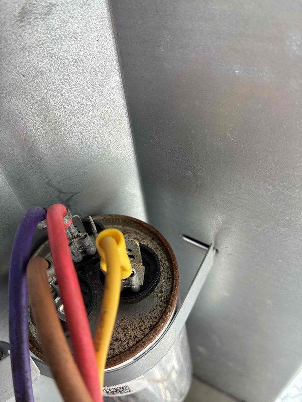 # HVAC Cooling System Maintenance - 10+ Years Old

Performed comprehensive preventive maintenance on aging air conditioning system. Conducted electrical diagnostics using multimeter to test capacitor functionality and verify proper voltage and amperage readings across all electrical connections. Inspected dual-run capacitor, contactor assembly, and associated wiring harness for signs of deterioration, loose connections, or component failure. All electrical connections were found secure with proper wire terminations. Capacitor tested within acceptable microfarad range. Contactor showed normal operation with no pitting or burning on contact points. Refrigerant lines exhibited expected surface oxidation consistent with system age but remain structurally sound with no evidence of leaks. System operational and functioning as designed following maintenance inspection.