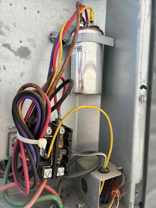 # HVAC Cooling System Maintenance - 10+ Years Old

Performed comprehensive preventive maintenance on aging air conditioning system. Conducted electrical diagnostics using multimeter to test capacitor functionality and verify proper voltage and amperage readings across all electrical connections. Inspected dual-run capacitor, contactor assembly, and associated wiring harness for signs of deterioration, loose connections, or component failure. All electrical connections were found secure with proper wire terminations. Capacitor tested within acceptable microfarad range. Contactor showed normal operation with no pitting or burning on contact points. Refrigerant lines exhibited expected surface oxidation consistent with system age but remain structurally sound with no evidence of leaks. System operational and functioning as designed following maintenance inspection.