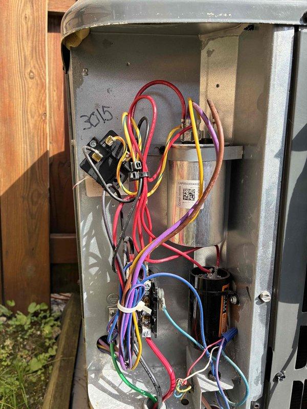 # HVAC Cooling System Maintenance

Performed routine cooling system maintenance on outdoor condensing unit as part of scheduled preventive maintenance program. Accessed electrical disconnect box and inspected internal components including capacitor, contactors, and associated wiring connections. Verified proper electrical connections across multiple circuits with red, yellow, purple, blue, green, and black conductor wiring. Utilized True RMS clamp meter to measure voltage, amperage, and electrical parameters to ensure system operating within manufacturer specifications. All electrical components tested and found functioning properly with no deficiencies noted. Unit operational and ready for cooling season.