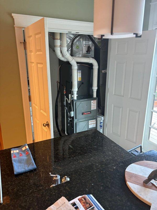 Completed full HVAC system installation including a 96% efficiency furnace, air conditioning condensing unit, and whole-home humidifier. The furnace was installed in an interior utility closet with proper PVC venting routed through the structure, and the outdoor condensing unit was positioned on a composite pad adjacent to the building exterior with refrigerant lines and electrical connections completed. All components were tested, commissioned, and left in proper working order with system operating to manufacturer specifications.