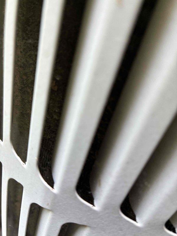 Completed routine cooling maintenance on residential air conditioning system. Inspected outdoor condenser unit and found accumulated dirt and debris between evaporator coil fins, which was cleaned to restore proper airflow and heat transfer efficiency. Performed electrical diagnostics using clamp meter to verify system amperage and confirm compressor operation within manufacturer specifications, with readings indicating normal performance at 296.9 amps. All components inspected and system operating properly upon completion.