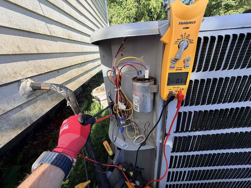 # HVAC Cooling System Maintenance

Performed comprehensive preventive maintenance on residential air conditioning system as part of scheduled recurring service plan. Conducted electrical diagnostics using digital multimeter to verify proper system operation, measuring voltage and amperage at the outdoor condenser unit. Accessed electrical disconnect box to test capacitor performance and inspect wire connections for signs of wear or overheating. All electrical components tested within manufacturer specifications. Verified condenser unit operation and confirmed refrigerant lines properly insulated. System operating efficiently with no issues identified during inspection.