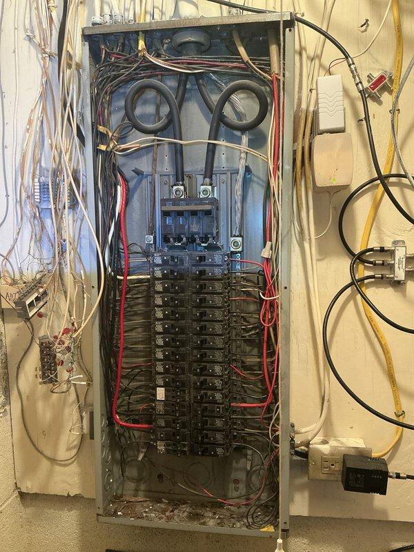 Completed comprehensive whole-home electrical inspection examining both exterior service entrance and interior distribution systems. Documented main utility meter installation, service entrance conductors, grounding connections, and weatherhead components at exterior meter base. Inspected main electrical panel, circuit breaker configuration, wire routing, and conductor terminations throughout the dwelling. All findings photographed for record-keeping and future reference.