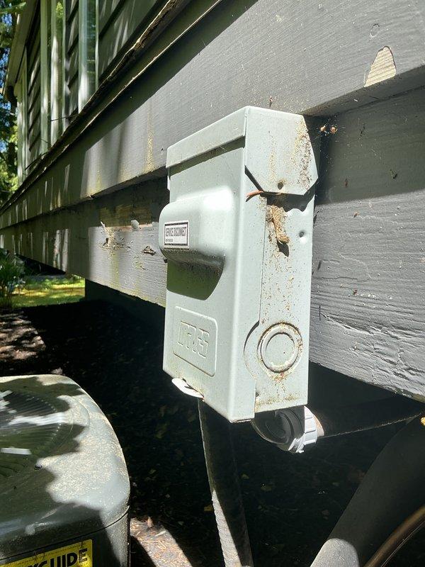 Completed scheduled cooling system maintenance on residential HVAC unit. Performed comprehensive inspection of outdoor condenser unit, electrical disconnect box, and associated components. Verified proper operation of disconnect switch and checked all electrical connections for signs of wear, corrosion, or loose terminations. Documented existing weathering and oxidation on exterior electrical enclosure hardware consistent with normal outdoor exposure. All system components found operating within normal parameters and unit ready for cooling season operation.