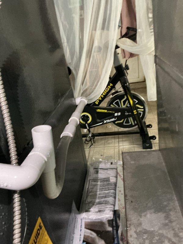 Responded to callback for leaking mini split system that was recently installed. Inspected indoor unit and refrigerant line connections in mechanical space. Documented condensate drain piping configuration and verified proper drainage slope. Photographed PVC drain lines, flexible refrigerant line set, and equipment installation to assess leak source and system condition for follow-up resolution.