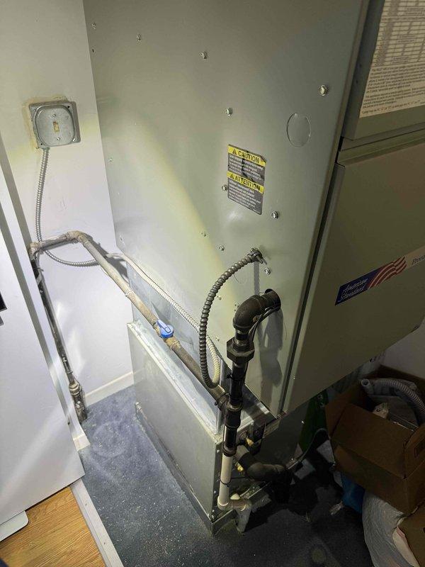 # HVAC Service Call - No Cooling Condition

Responded to service call for central air conditioning system with no cooling capability. Upon arrival, customer reported complete loss of cooling function with system age unknown.

## Diagnostic Procedures

Performed comprehensive system evaluation of residential split-system air conditioning unit located in interior mechanical closet. Conducted visual inspection of air handler cabinet and associated components. Examined electrical connections at junction box and verified whip connector integrity to unit. Inspected condensate drain lines and refrigerant line connections at base of air handler.

Evaluated ductwork connections and flexible duct routing from air handler. Checked system labels and manufacturer specifications on equipment panels. Assessed overall condition of installation including clearances and accessibility in confined mechanical space.

## Findings

System inspection revealed air handler unit in mechanical closet with standar