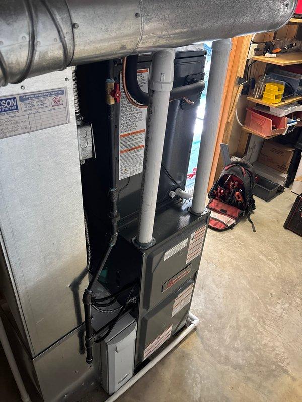 Completed full HVAC system installation including 96% efficiency furnace and heat pump air conditioner section (Model CAPTA3625B3AA). Installed new furnace unit with internal gray PVC venting system, connected ductwork, and verified proper clearances and ventilation requirements. Heat pump section rated for A2L refrigerant safety group with proper charge specifications and maximum outlet temperature of 200°F. All equipment properly labeled with manufacturer specifications, electrical requirements verified at 24 volts/60 Hertz, and ETL Intertek certification confirmed. System installed in basement utility area with access panels secured and all safety labels visible for future service reference.