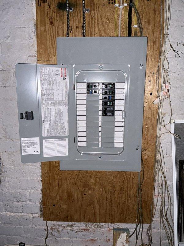 Conducted site assessment for air conditioning system addition to existing property with boiler heating system. Evaluated electrical panel capacity and attic space configuration to determine feasibility and requirements for AC installation, documenting existing infrastructure including electrical service and available mounting locations for indoor air handler unit.