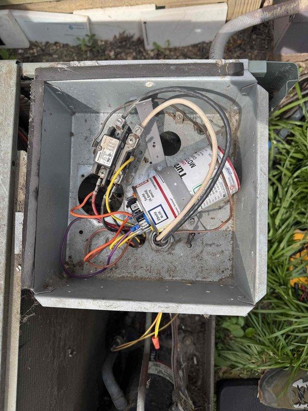 Responded to emergency no-cooling call for a 2005 central air conditioning system. Upon arrival, found unit running with airflow present but unable to maintain temperature setpoint, with indoor temperature remaining at 76°F despite thermostat set to 73°F before system shutdown. Inspected outdoor condensing unit and identified failed condenser fan motor with multiple disconnected wire terminals visible in control compartment. Documented equipment condition showing significant age-related wear, corroded wiring connections, and accumulated debris in motor housing. System is approximately 18-19 years old and approaching end of serviceable life expectancy for residential HVAC equipment.