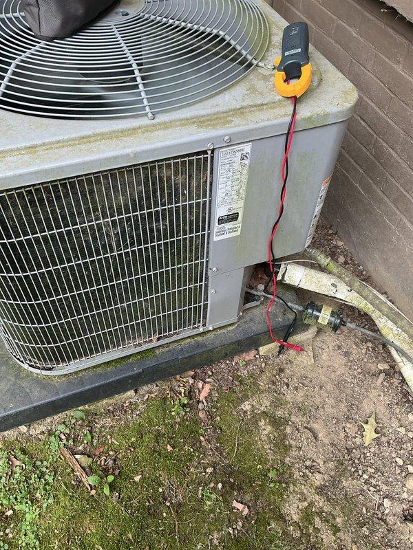 Completed cooling maintenance on outdoor condensing unit. Performed electrical diagnostics using clamp meter, recording compressor amperage at 15.02 amps. Inspected condenser coils, fan assembly, and electrical connections. Unit operating within normal parameters at time of service.