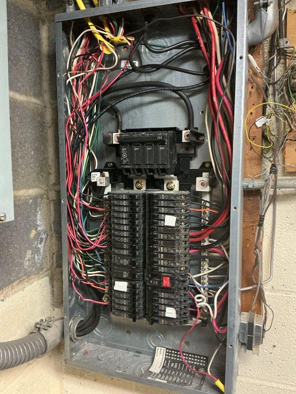 Completed comprehensive electrical inspection of residential panel and HVAC system. Documented electrical panel configuration showing dual-row circuit breaker arrangement with main disconnect, noting wire management and routing of branch circuits throughout the enclosure. Inspected HVAC electrical connections including refrigerant line set and associated wiring at evaporator coil location. Captured photographic documentation of all inspected components for record-keeping purposes.