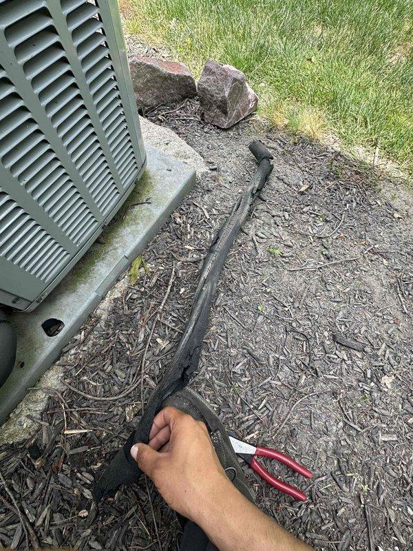 Completed cooling system tune-up and inspection on residential HVAC unit. Customer reported deteriorated insulation covering on refrigerant line set between outdoor condenser and building exterior; observed and documented damaged line set insulation requiring replacement. Recorded supply air temperature of 58°F during system operation.