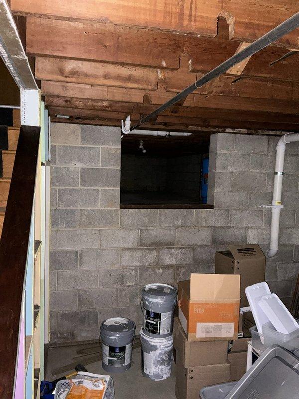 Conducted site assessment for customer requesting mini split installation options and separate quote for full ductwork system in attic with outdoor AC unit. Customer currently has boiler heat and is exploring cooling solutions. Documented attic space with exposed wooden joists and unfinished ceiling structure, noting existing electrical wiring and basic lighting fixture, as well as basement area with concrete block walls, exposed floor joists, and available space for potential equipment placement.