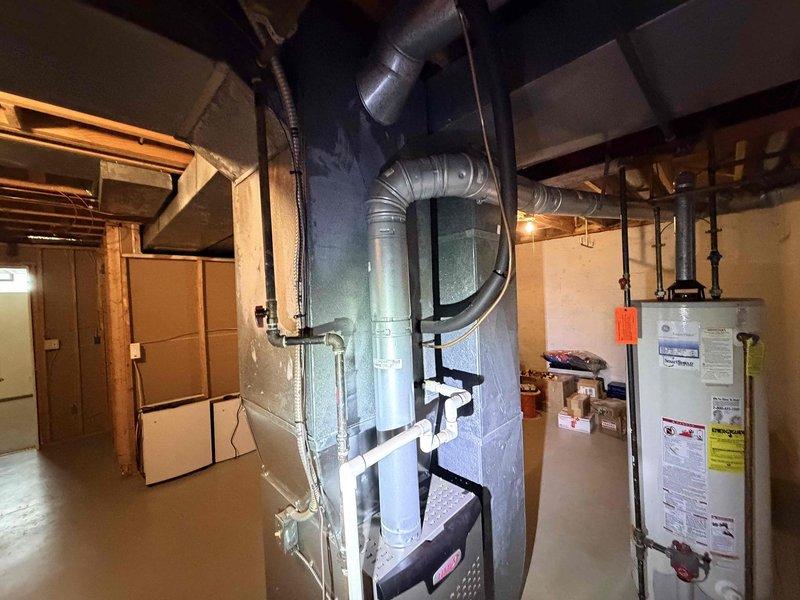 # HVAC Service Call - No Cooling Complaint

Responded to no cooling complaint on 35-year-old residential HVAC system. Upon arrival, performed visual inspection of basement-installed furnace and air handler unit with associated ductwork and refrigerant lines. Documented existing equipment condition through photographs showing aged system with metallic ductwork, copper refrigerant piping, and overall installation layout.

Given the advanced age of the system (35 years) and customer's request for repair estimate if fixable, assessed equipment for viability of repair versus replacement. Standard residential HVAC systems have typical service life of 15-20 years, making this unit well beyond expected operational lifespan. Evaluated system components including air handler, ductwork connections, refrigerant line routing, and overall mechanical condition.

Provided customer with professional assessment of system status and prepared replacement estimate as requested due to age-related concerns a