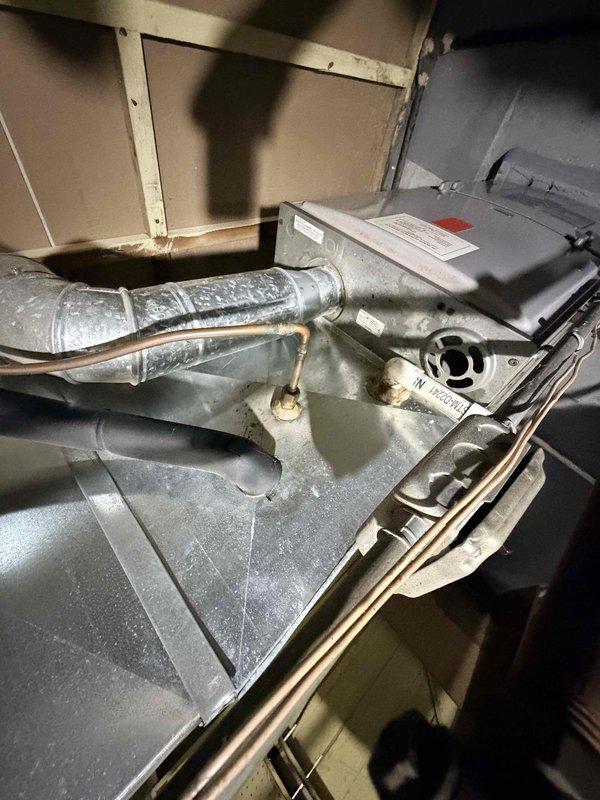 Responded to no-cooling complaint on central air conditioning system with reported loud vibration noise and inability to maintain thermostat setpoint. Upon arrival, inspected outdoor condenser unit and indoor air handler located in attic space. Identified aging equipment with mechanical failure requiring immediate attention. Due to system age exceeding 10 years and extent of necessary repairs, recommended complete system replacement. Customer approved replacement of existing unit with new high-efficiency system. Removed old condenser unit from exterior gravel pad and disconnected indoor air handler from ductwork and refrigerant lines. Installed new outdoor condensing unit on existing concrete pad, ensuring proper leveling and clearances from structure and fence line. Mounted new air handler in attic space, connecting to existing flexible ductwork and establishing new refrigerant line set. Performed vacuum and refrigerant charge per manufacturer specifications. Tested system operation, 