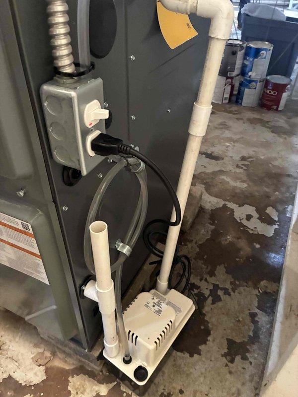 Completed full HVAC system installation including 96% efficiency furnace and air conditioning unit to resolve no cooling condition. Installed new furnace with proper venting via white PVC piping, connected air handler with flexible metallic ductwork, and set up condensate pump system with clear drainage tubing. Verified system operation with temperature readings confirming proper cooling performance at 53.9°F output.