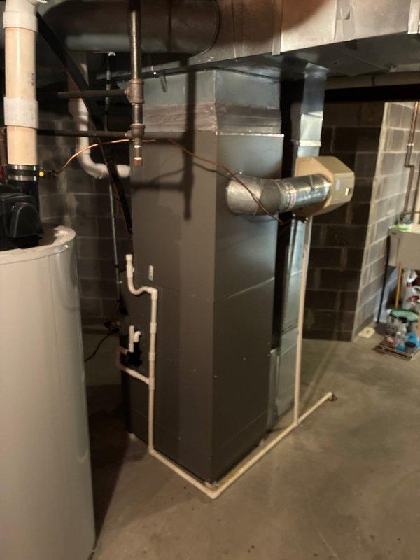 Completed installation of new Lennox air conditioning system to address no cooling condition. Installed outdoor condensing unit on composite pad with proper landscaping clearance and connected to existing furnace system in basement mechanical room. System charged with R-454B refrigerant, tested all electrical connections, verified proper airflow, and confirmed unit operation within manufacturer specifications.