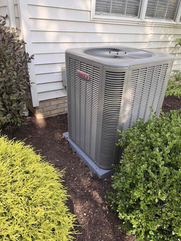 Completed installation of new Lennox air conditioning system to address no cooling condition. Installed outdoor condensing unit on composite pad with proper landscaping clearance and connected to existing furnace system in basement mechanical room. System charged with R-454B refrigerant, tested all electrical connections, verified proper airflow, and confirmed unit operation within manufacturer specifications.
