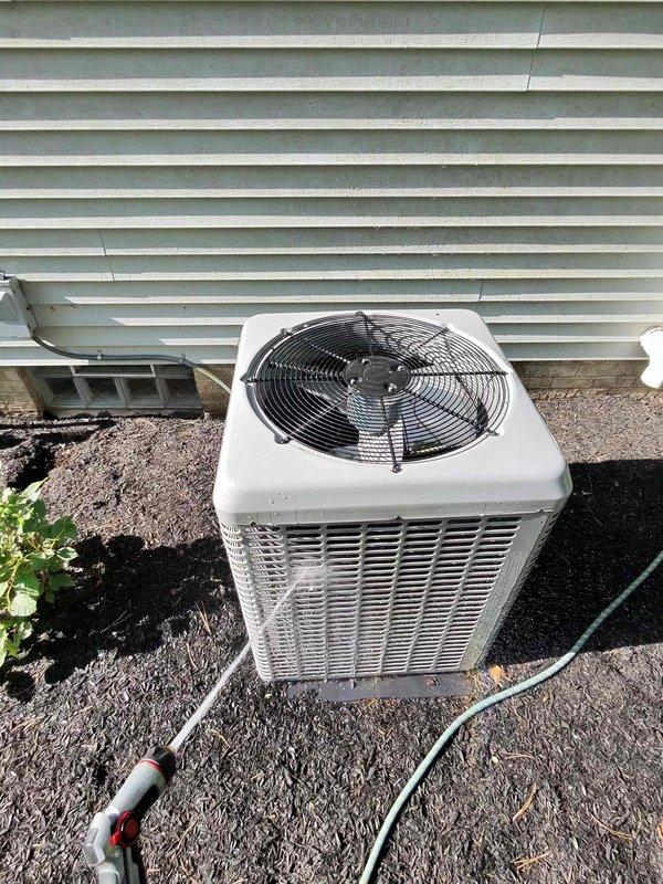 Completed routine cooling system maintenance on residential split-system air conditioner. Performed exterior condenser unit cleaning, removing debris from coil fins and verifying proper airflow through the unit. Inspected evaporator coil assembly and condensate drain lines for proper operation, noting typical dust accumulation on indoor coil fins. Verified refrigerant line connections, checked system components for wear, and confirmed all electrical connections were secure. System operational and ready for continued service.