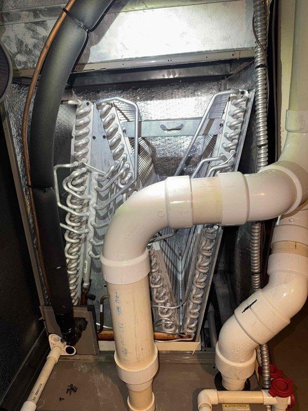 Completed routine cooling system maintenance on residential split-system air conditioner. Performed exterior condenser unit cleaning, removing debris from coil fins and verifying proper airflow through the unit. Inspected evaporator coil assembly and condensate drain lines for proper operation, noting typical dust accumulation on indoor coil fins. Verified refrigerant line connections, checked system components for wear, and confirmed all electrical connections were secure. System operational and ready for continued service.
