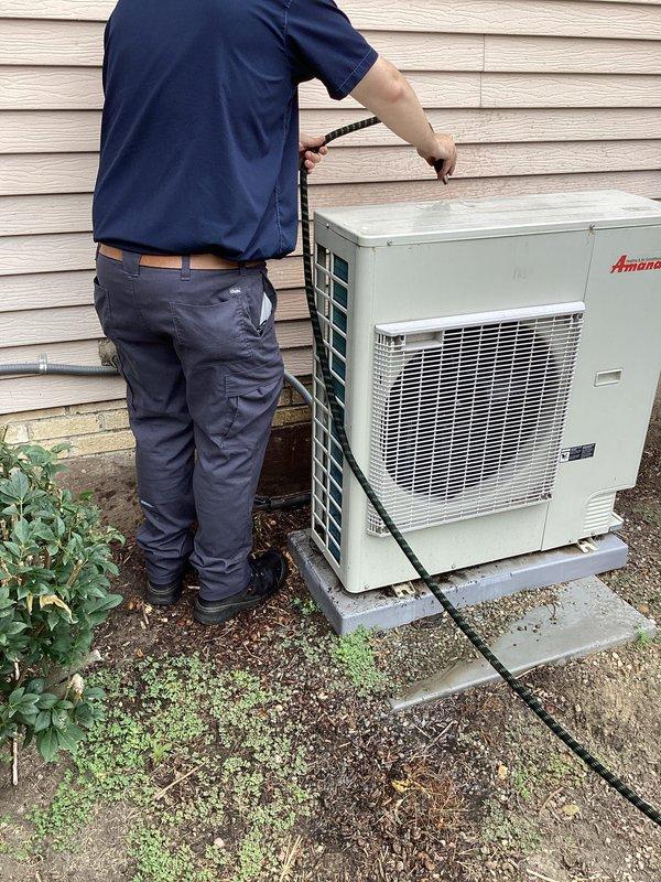 # HVAC Cooling Maintenance Completed

Performed comprehensive preventive maintenance service on residential Amana air conditioning system as part of ongoing service plan agreement. Conducted thorough inspection of outdoor condenser unit, including examination of top panel access points and verification of proper component operation. Inspected internal mechanical assemblies, motor components, and electrical connections to ensure optimal system performance. All wiring connections, including color-coded electrical pathways, were verified for secure attachment and proper routing. Examined refrigerant lines and electrical conduit connections at exterior wall junction point. System found to be operating within normal parameters with no immediate service needs identified. Unit left in proper working condition for continued cooling season operation.