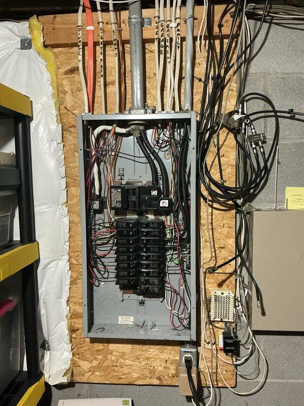 Completed comprehensive electrical inspection of residential property. Documented main electrical service panel installation with circuit breaker configuration, incoming service conductors, and proper grounding connections. Panel showed multiple branch circuits with appropriate color-coded wiring (red, black, white conductors) terminated to breakers and bus bars. Verified conduit runs and cable management above panel box. Also inspected and photographed HVAC/mechanical system connections in crawl space area, including PVC drain lines, copper refrigerant lines with proper mounting brackets, and surrounding insulation installation. All observations captured photographically for documentation purposes.