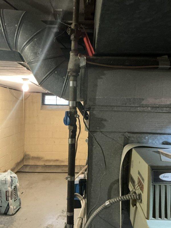 Responded to no cooling call and performed system evaluation. Upon inspection, observed existing HVAC system with basement installation showing signs of age and potential efficiency concerns. Evaluated thermostat operation and overall system condition, noting wall discoloration near control unit that may indicate previous moisture issues or equipment cycling problems. Assessed ductwork configuration and equipment placement in basement utility area. Presented customer with replacement options for complete air conditioning system upgrade to restore cooling functionality and improve energy efficiency.