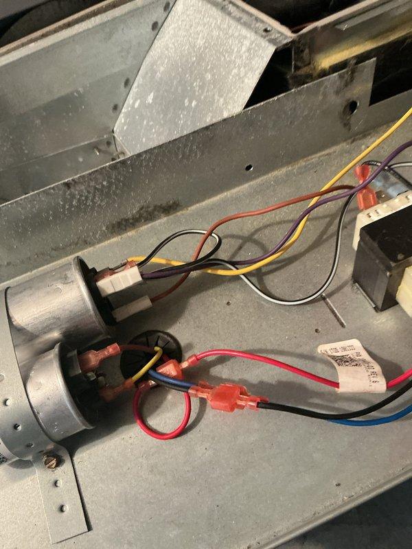 Replaced defective blower motor and wheel assembly in air handler unit. Disconnected and removed failed motor, installed new blower motor and wheel, reconnected all electrical wiring to capacitors and terminals, and verified proper operation of the system upon completion.