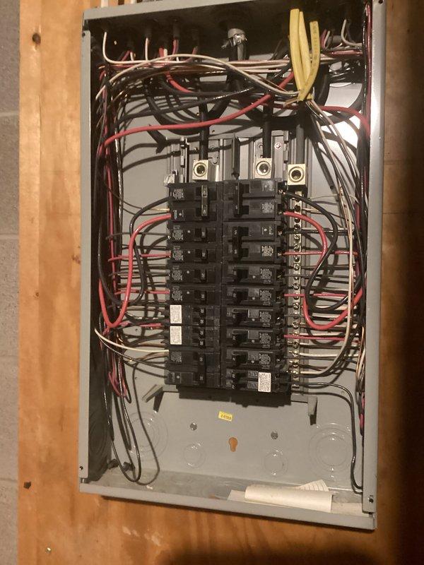Conducted comprehensive electrical inspection of residential property during renovation phase. Documented electrical panel installation featuring dual-column circuit breaker configuration with main service lugs and proper wire routing through metal enclosure. Inspected exposed ceiling infrastructure including metallic conduit runs and mounting systems in construction area with visible structural elements. Captured photographic documentation of all electrical components and installations for compliance records.