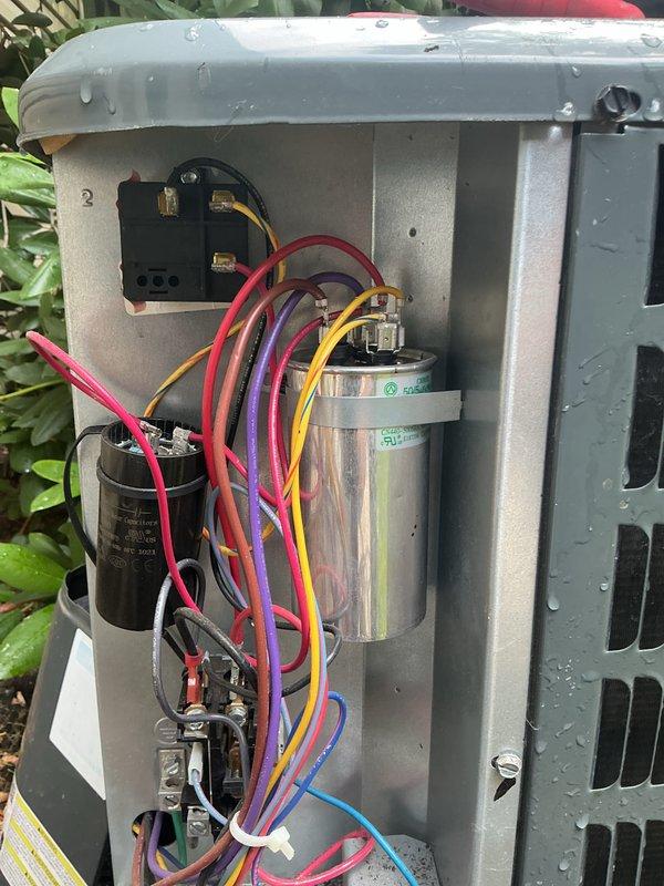 Performed routine HVAC cooling maintenance inspection with focus on electrical components. Accessed outdoor condensing unit and inspected dual capacitor assembly, verifying proper connections and terminal integrity across all wire harnesses including compressor and fan motor circuits. Examined indoor air handler system including UV-C light purification unit, confirming operational status and proper installation of all electrical safety devices and associated PVC drainage lines.