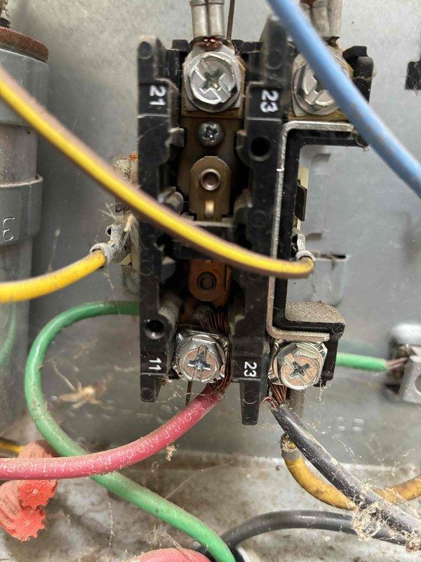 # HVAC Cooling Maintenance Completed

Performed comprehensive cooling system maintenance on residential air conditioning unit. Conducted thorough electrical diagnostics using digital clamp meter, measuring voltage and amperage at contactor terminals to verify proper electrical operation. Inspected terminal block connections, identifying multiple wires showing signs of age deterioration and frayed insulation on green and red conductors. All electrical connections were secured and verified for proper contact. Measured system performance parameters including voltage readings and current draw to ensure unit operating within manufacturer specifications. Inspected condenser coil and associated components for proper operation. System tested and confirmed operational upon completion of maintenance service.