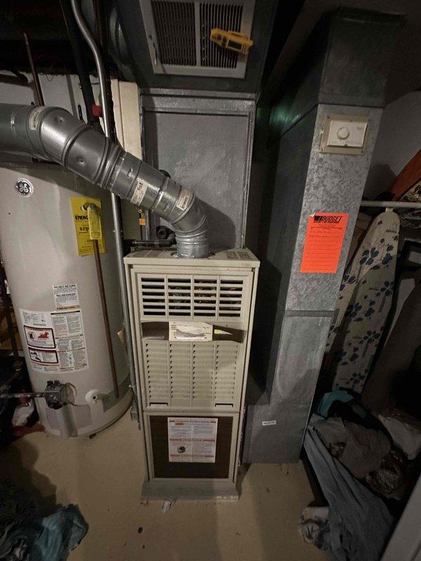 # HVAC Service Call - No Cooling Complaint

Responded to service call for central air conditioning system with no cooling complaint. Upon arrival, contacted customer as requested and proceeded with system diagnostics.

Performed temperature measurements at supply registers using calibrated digital thermometer. Initial readings indicated supply air temperature of 62.0°F at the register, suggesting insufficient cooling capacity or potential system malfunction. Normal supply air temperatures for properly operating AC systems typically range between 55-60°F with adequate temperature split from return air.

Conducted visual inspection of HVAC equipment located in basement mechanical room. System consists of forced air furnace with integrated cooling coil and standard ductwork configuration. Equipment observed alongside residential water heater in utility space. All major components accessed and visually assessed for obvious signs of failure or operational issues.

Documented equipment condi