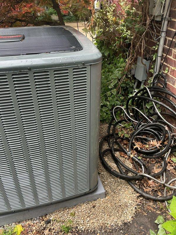 Responded to customer concern regarding inadequate gravel support beneath air conditioning condenser unit. Upon inspection, found one corner of the condenser pad had insufficient pebble base material, creating an unstable foundation. Added and leveled gravel beneath the affected corner to ensure proper support and prevent future settling or tilting of the unit. Verified condenser unit was level and stable on all corners after adjustment. Unit operating normally with no mechanical issues identified.