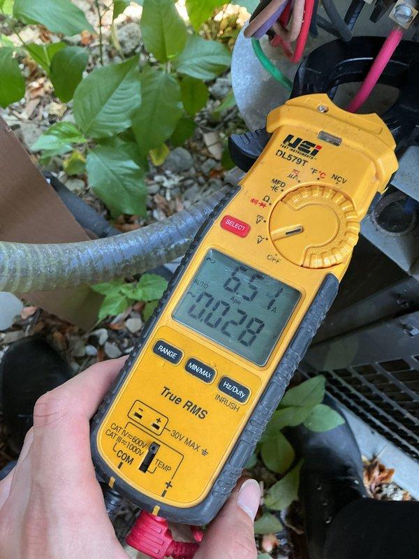 Completed scheduled preventive maintenance on residential cooling system. Performed thorough inspection of blower assembly, confirming squirrel cage fan wheel operating cleanly with no debris accumulation and all blades intact. Verified motor shaft coupling secure with proper setscrew tension. Measured electrical parameters using digital multimeter, recording voltage readings at 63.57V to confirm proper system operation. Inspected outdoor unit components and refrigerant line insulation for integrity. System operating within normal parameters with no deficiencies noted.