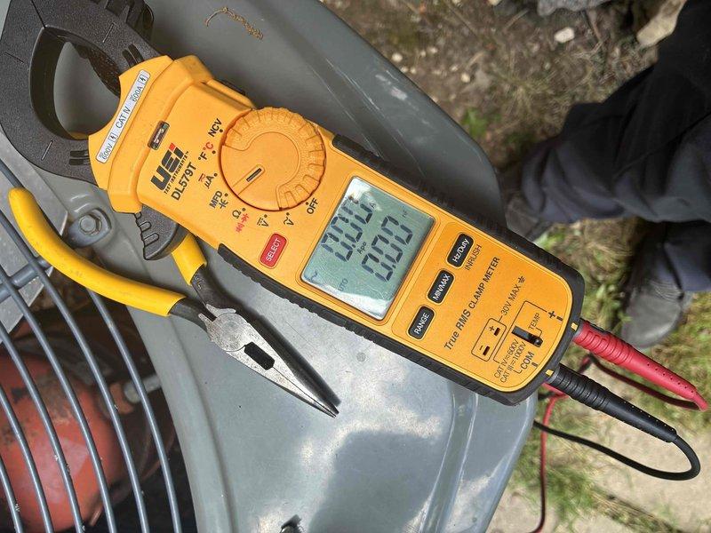 Responded to no cooling complaint affecting entire home. Upon inspection, discovered failed dual run capacitor with severe rust and corrosion on terminals and mounting bracket. Removed defective capacitor and installed new replacement unit. Verified proper amperage draw and system operation using clamp meter, confirming compressor and condenser fan motor running within manufacturer specifications. System restored to normal cooling operation.