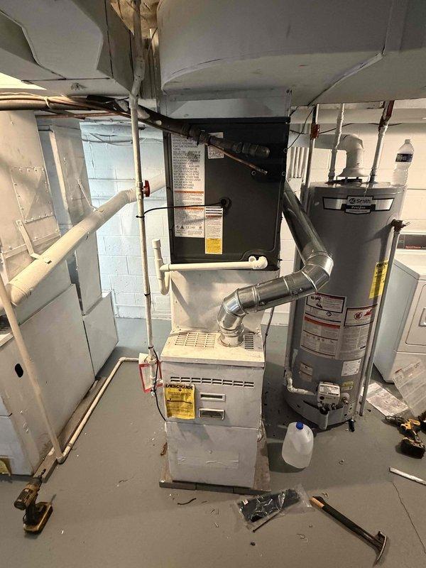Completed installation of new air conditioning system in residential basement mechanical room. Connected refrigerant lines, electrical wiring, and integrated new AC unit with existing furnace infrastructure. Verified proper operation of condensate drainage through PVC piping, tested system startup, and confirmed cooling functionality meets manufacturer specifications.