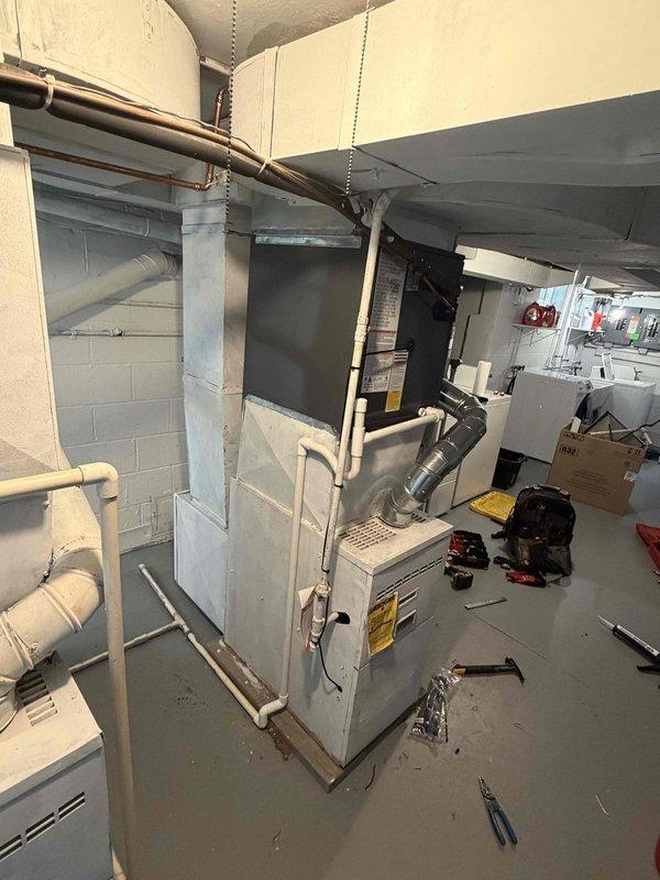 Completed installation of new air conditioning system in residential basement mechanical room. Connected refrigerant lines, electrical wiring, and integrated new AC unit with existing furnace infrastructure. Verified proper operation of condensate drainage through PVC piping, tested system startup, and confirmed cooling functionality meets manufacturer specifications.