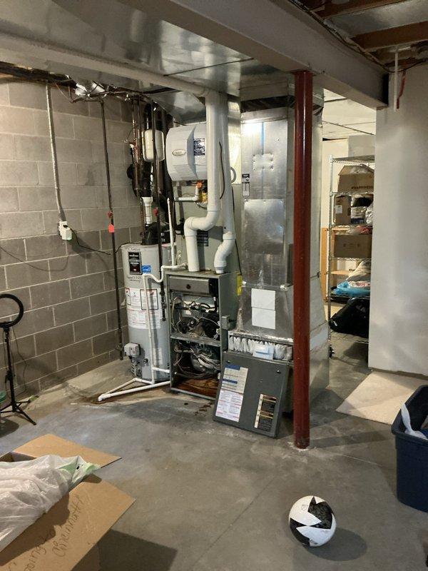 Conducted comprehensive assessment of non-functional residential HVAC system in basement mechanical room. Evaluated existing furnace, ductwork configuration, and air handler setup to provide full system replacement options. Documented current equipment condition and installation space parameters including concrete block wall mounting locations, existing PVC condensate drainage, metal ductwork routing, and electrical service accessibility. Presented multiple replacement system solutions to address complete loss of cooling functionality.