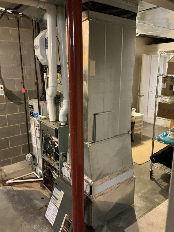 Conducted comprehensive assessment of non-functional residential HVAC system in basement mechanical room. Evaluated existing furnace, ductwork configuration, and air handler setup to provide full system replacement options. Documented current equipment condition and installation space parameters including concrete block wall mounting locations, existing PVC condensate drainage, metal ductwork routing, and electrical service accessibility. Presented multiple replacement system solutions to address complete loss of cooling functionality.