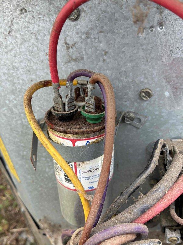Responded to service call for air conditioning system not maintaining desired temperature at thermostat setpoint. Upon arrival, found 20-year-old outdoor condensing unit with aged electrical components showing significant wear and weathering. Performed diagnostic evaluation of system operation and inspected electrical connections including contactor and run capacitor. Documented condition of electrical components with photographs showing deteriorated wiring insulation, dust accumulation, and aged capacitor with faded labeling. Confirmed best contact number for follow-up communication regarding system performance and repair recommendations for aging equipment.