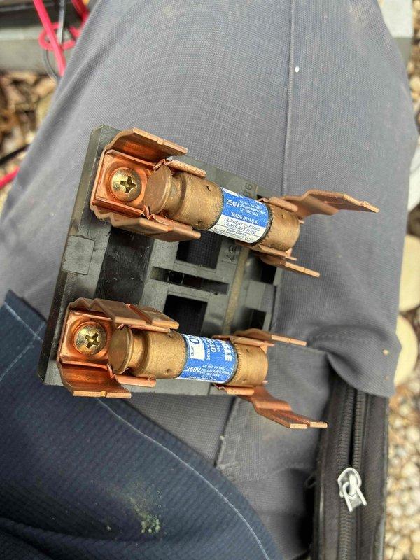 Completed routine HVAC cooling maintenance on Trane outdoor unit. Electrical measurements were not available during this service visit, but dual copper fuses and fuse block were inspected and found to be in proper working condition with no signs of damage or deterioration.