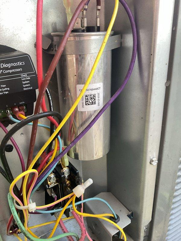 Arrived on-site to perform scheduled cooling maintenance on two HVAC systems. Upon inspection, determined that furnace units were inoperable, preventing completion of full system maintenance at this time. Documented outdoor condenser unit condition and internal electrical components including capacitor and diagnostic module, then coordinated rescheduling of service for later in the week to address furnace issues and complete comprehensive maintenance on both systems.
