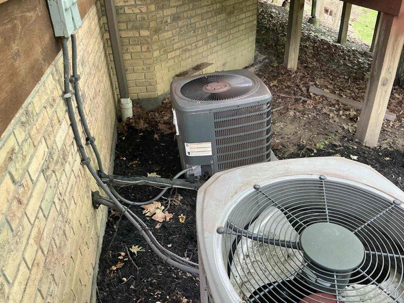 Responded to no cooling complaint on residential air conditioning system. Evaluated existing outdoor condensing unit and provided replacement estimate options for failed equipment. Documentation photos captured multiple HVAC units installed at property exterior beneath elevated deck structure, showing current system configuration and installation environment.